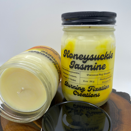 two coconut soy candles in glass jars with black lids Scent: Honeysuckle Jasmine, Color: White and Yellow swirled 